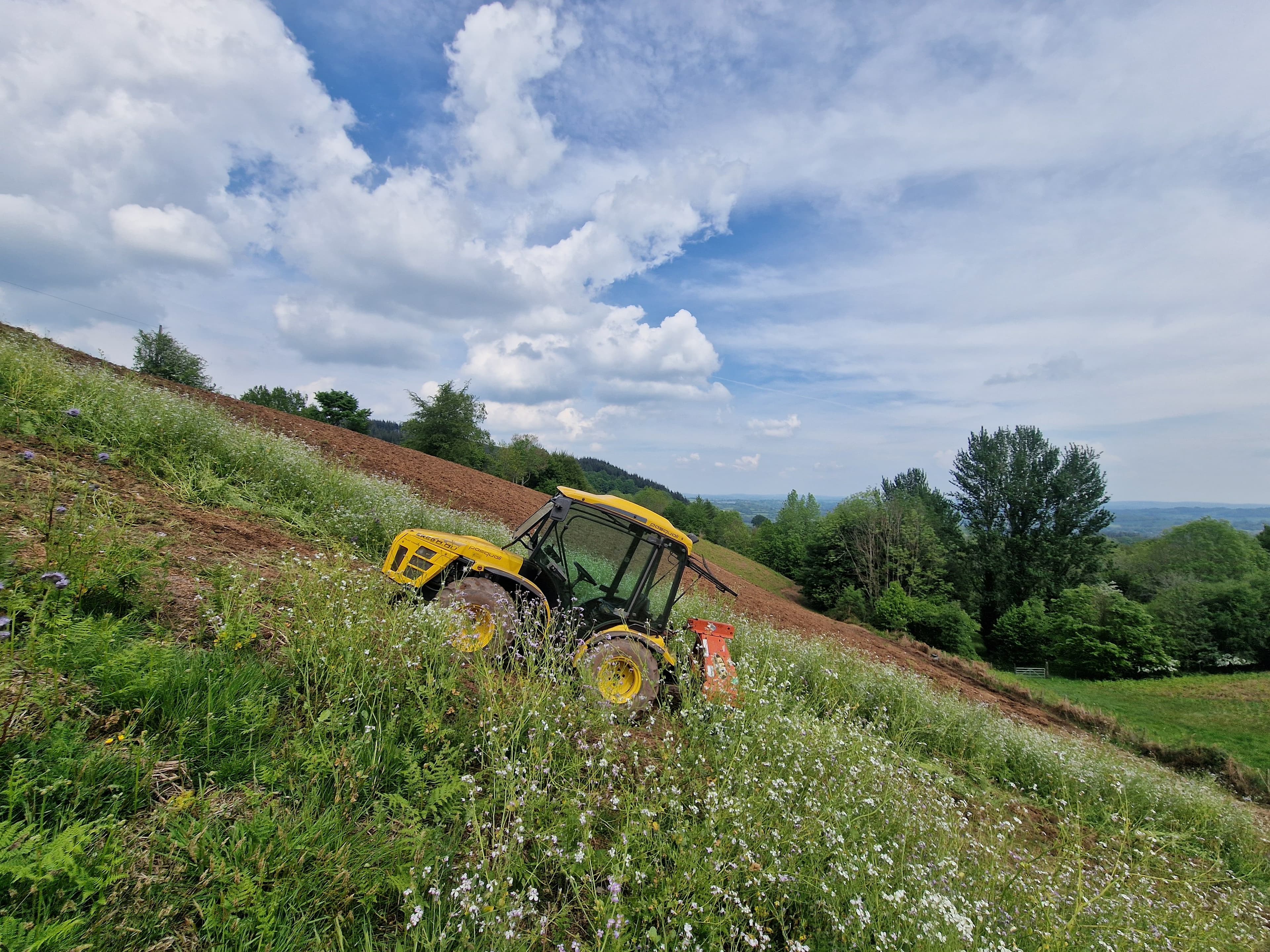 Working the steep Ochram slope, the valley falling away beyond